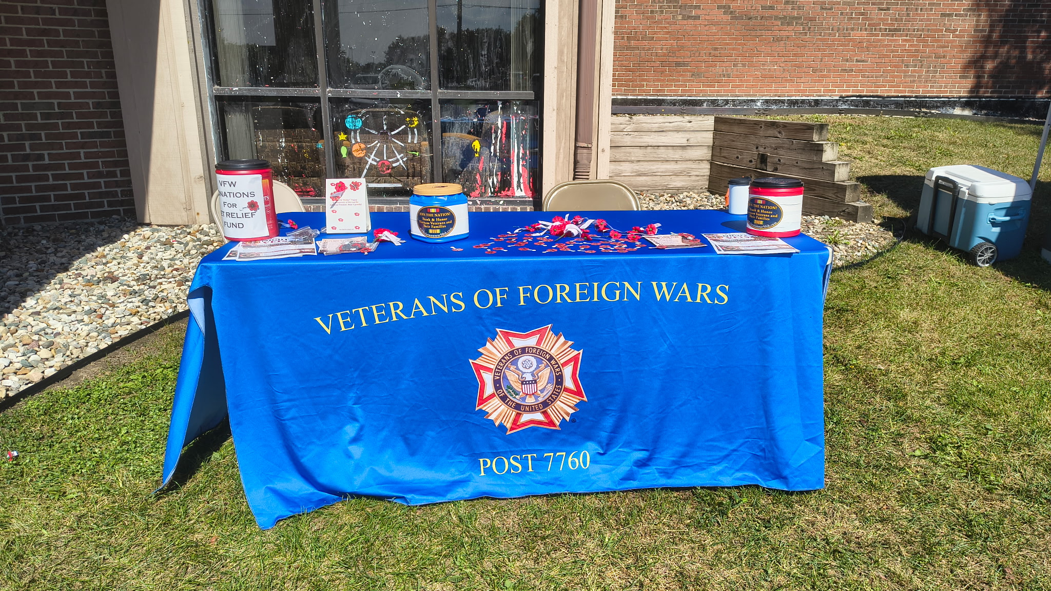 VFW Post 7760 donation table with poppy collection cans and Veterans Relief Fund materials at Hogs For Hope