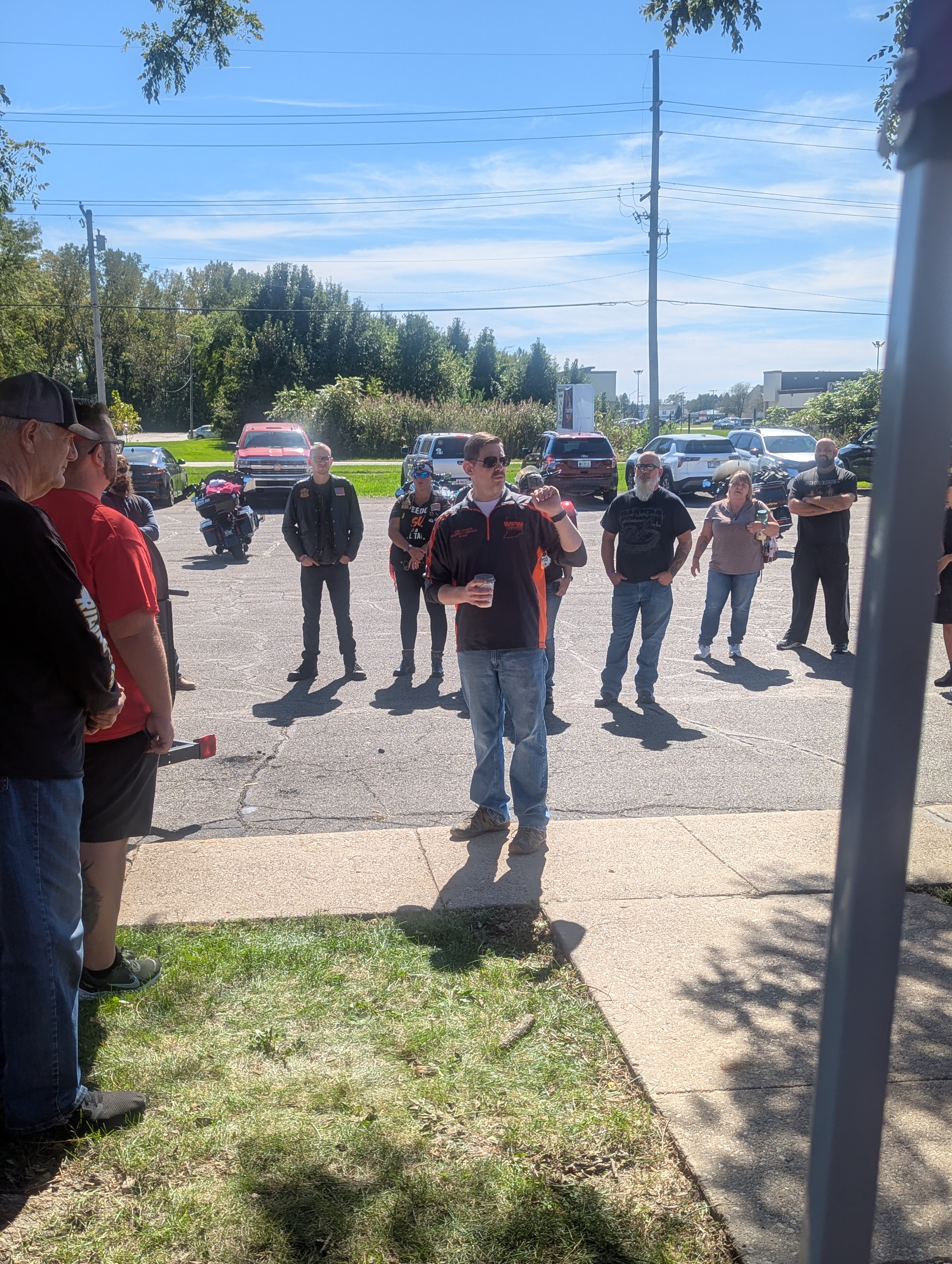 VFW Post 7760 member addressing riders gathered in the parking lot before the Hogs For Hope charity ride